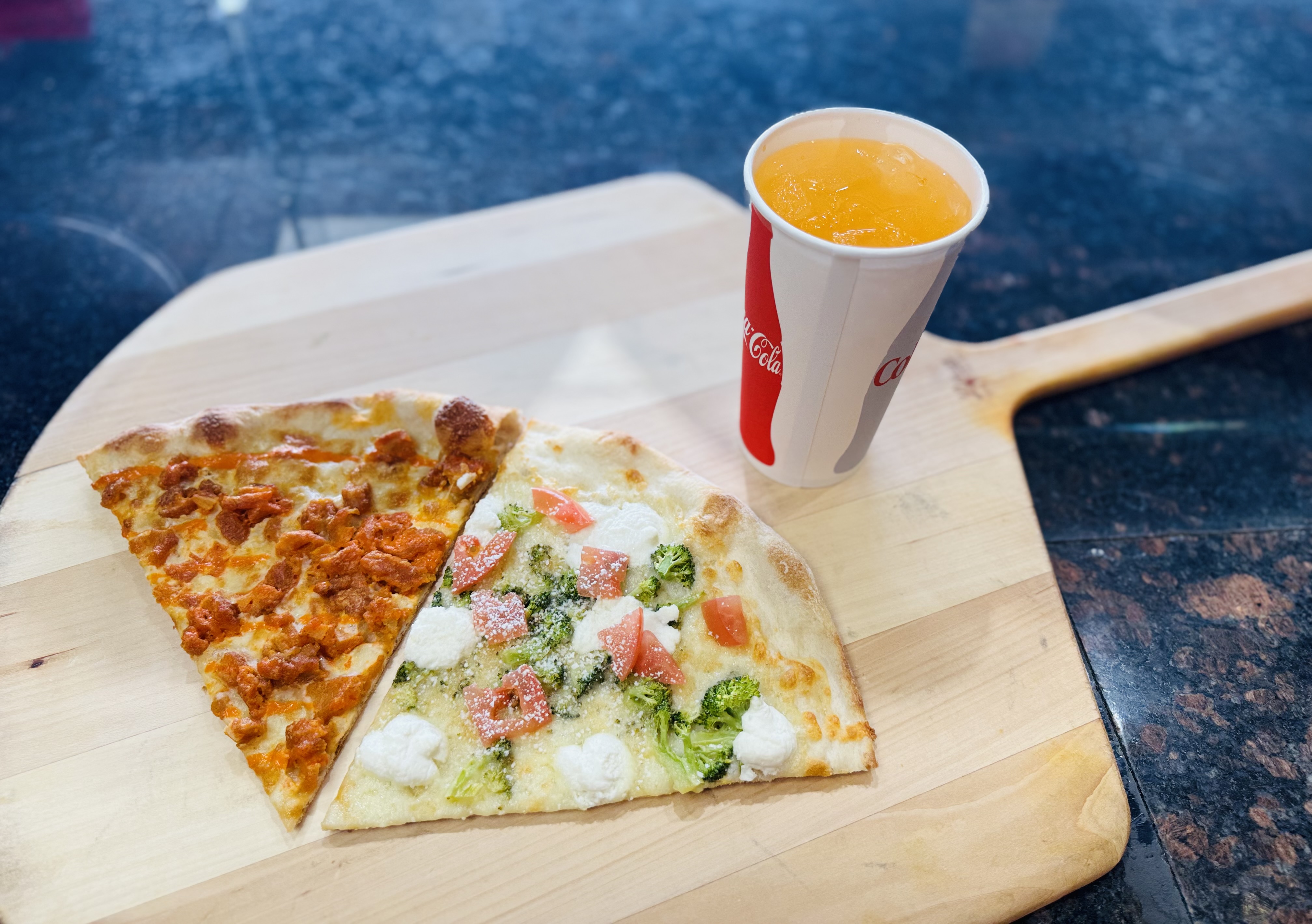 Two specialty slices - buffalo chicken and broccoli tomato ricotta and a fountain soda.