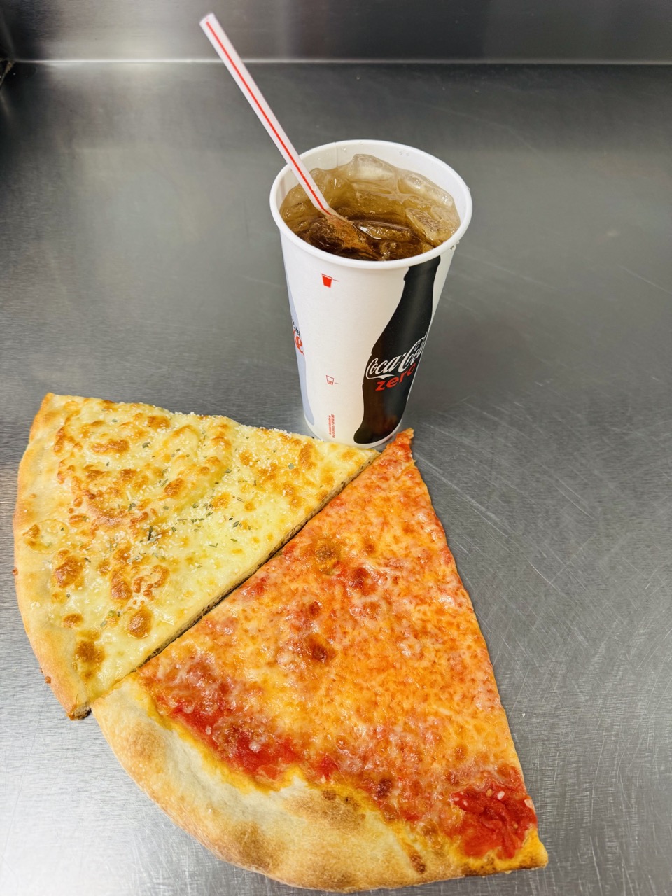 Two plain cheese slices and a fountain soda